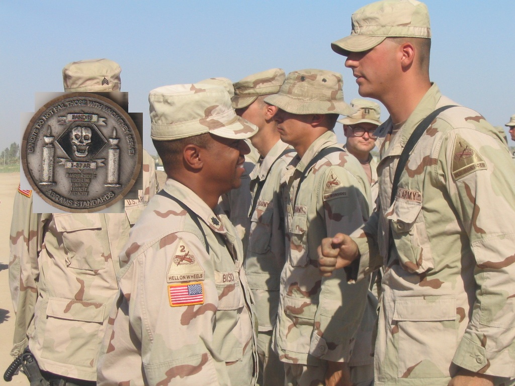 LT. COL Bishop, XO of 1-37 AR 'Bandits,' presenting coins for Karbala support, 2004